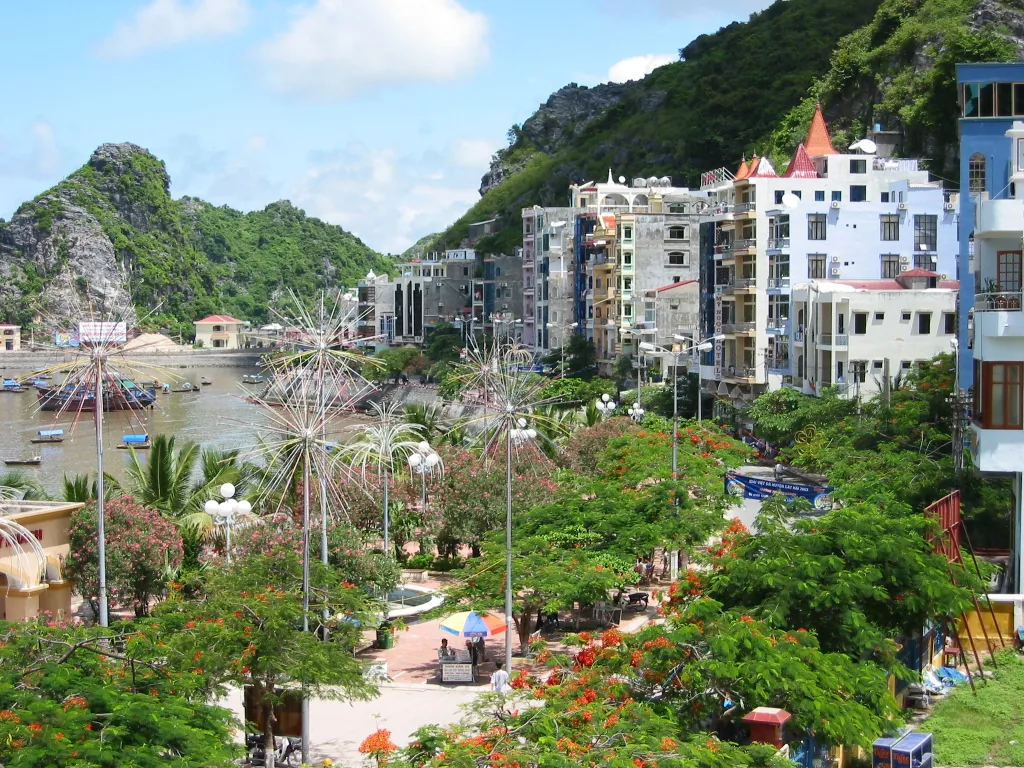 View of Cat Ba Town harbor with limestone karsts in the background