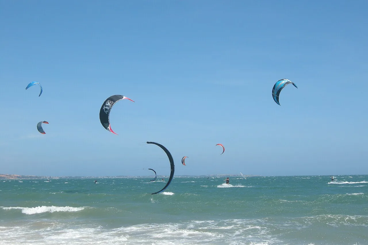Kitesurfers riding the strong trade winds at Mui Ne beach