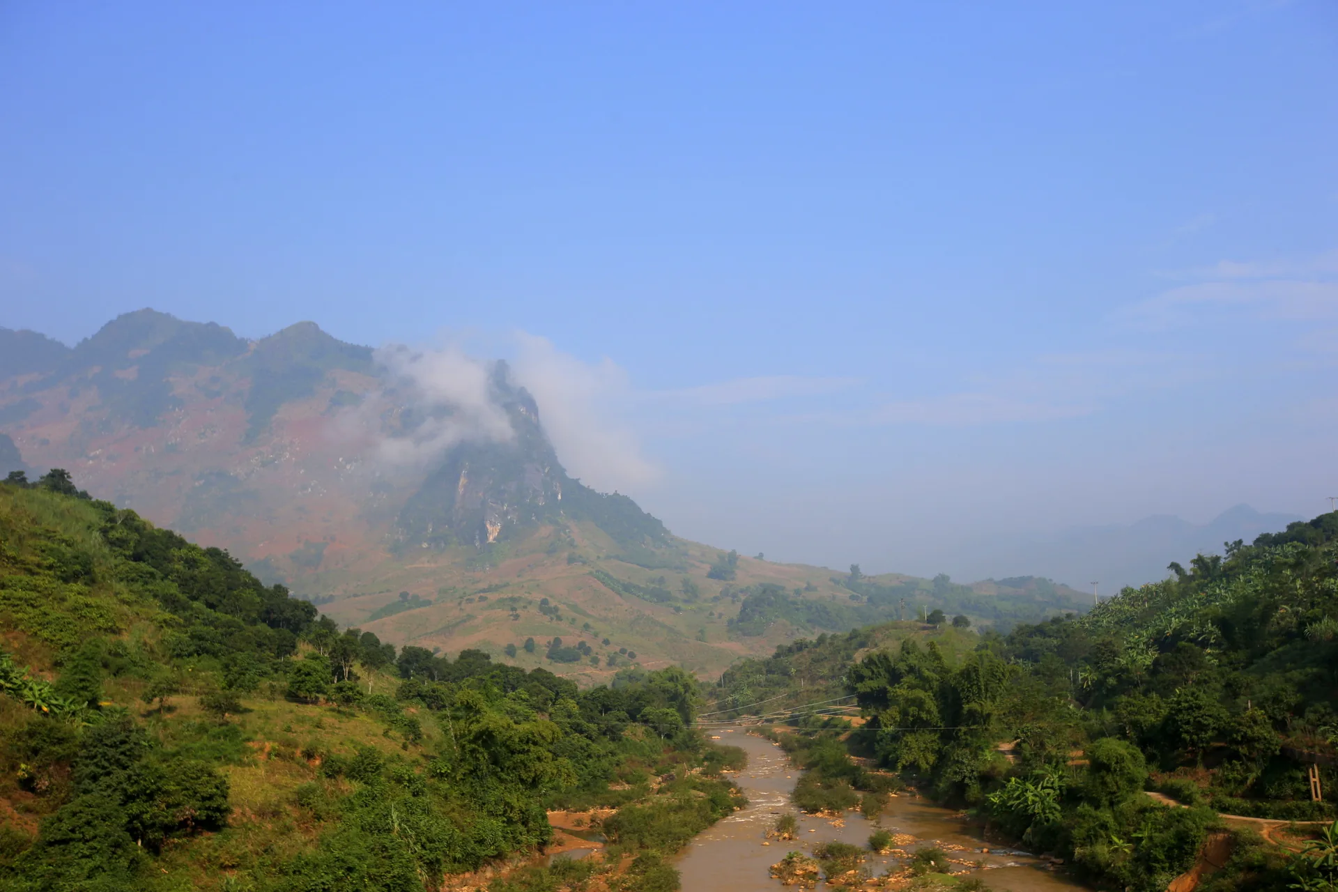 Son La Vietnam — the highland plateau approach to Moc Chau offers sweeping views over the Thai and Muong communities of northwestern Vietnam
