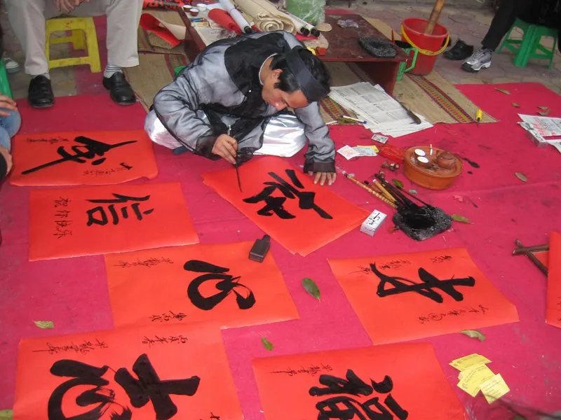 Tet Vietnam lunar new year celebration — red and gold decorations fill markets and homes across the country