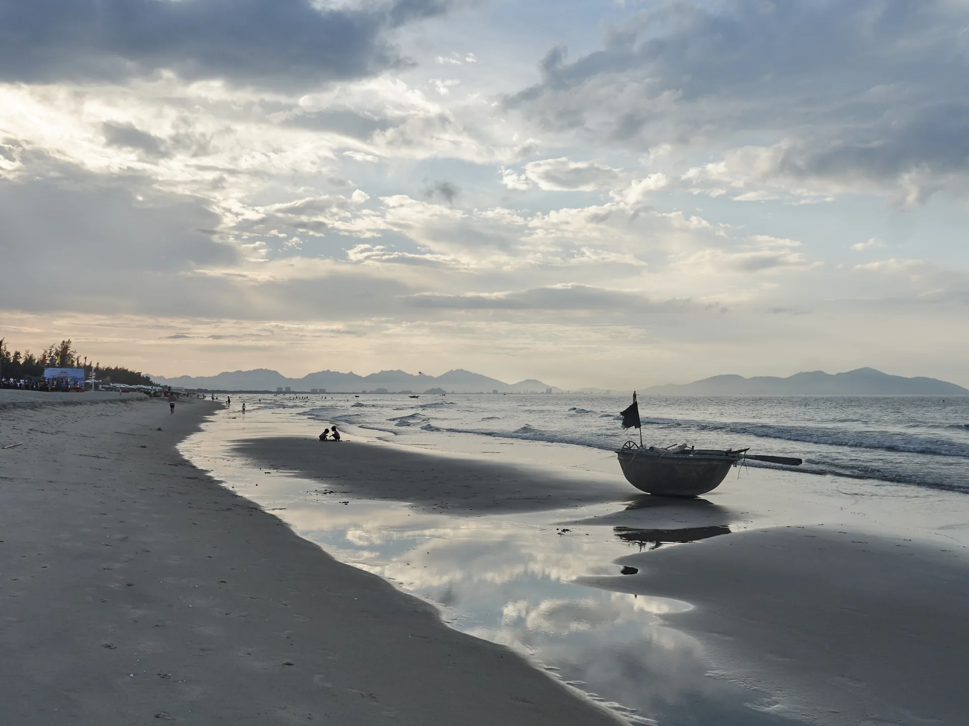 An Bang beach near Hoi An — fishing boats share the sand with sunbathers at this relaxed stretch