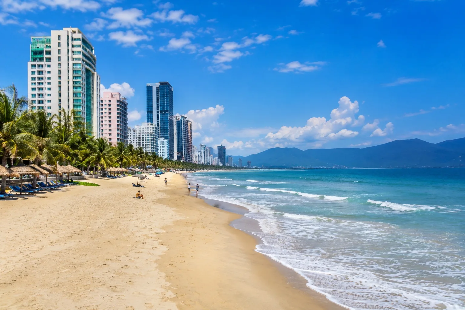 Da Nang's golden sand beach at sunset with the Dragon Bridge in the background