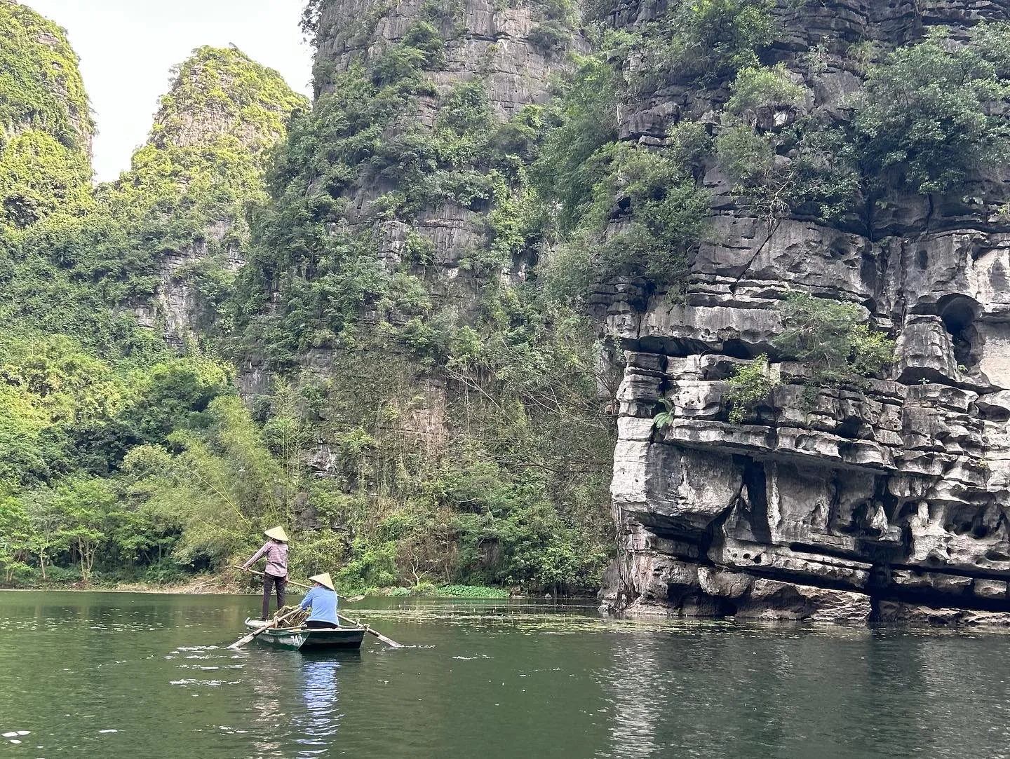 Ninh Binh karst boat tour Vietnam — flat-bottomed rowing boats through limestone valleys are perfect for children