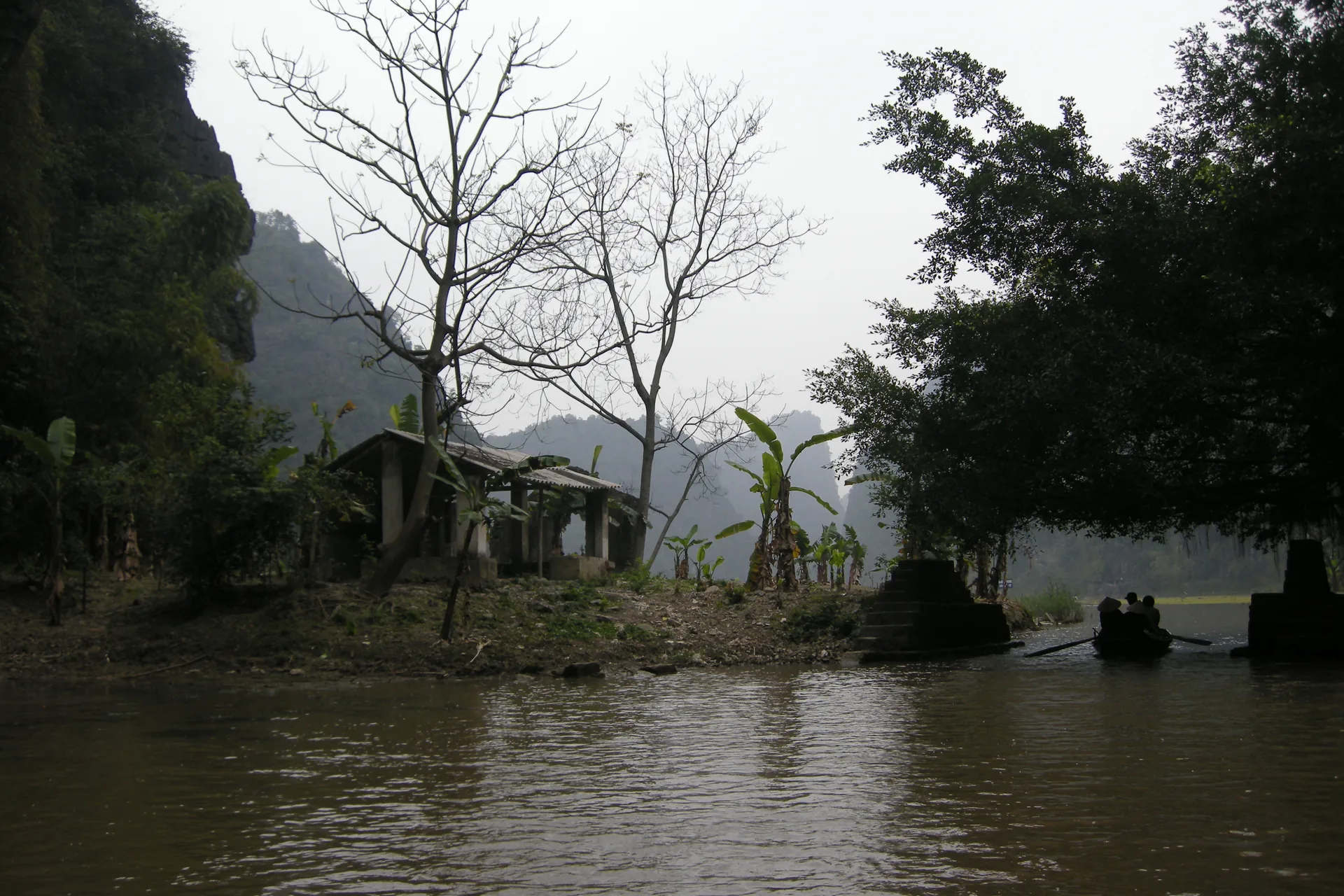 Ninh Binh karst landscape Vietnam — the flooded valleys produce mirror reflections that disappear once boats disturb the water